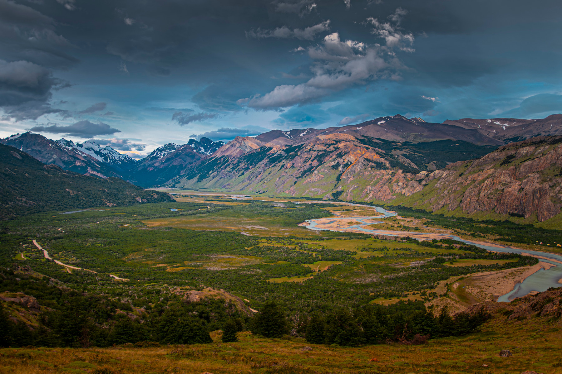 A braided valley under a breaking storm